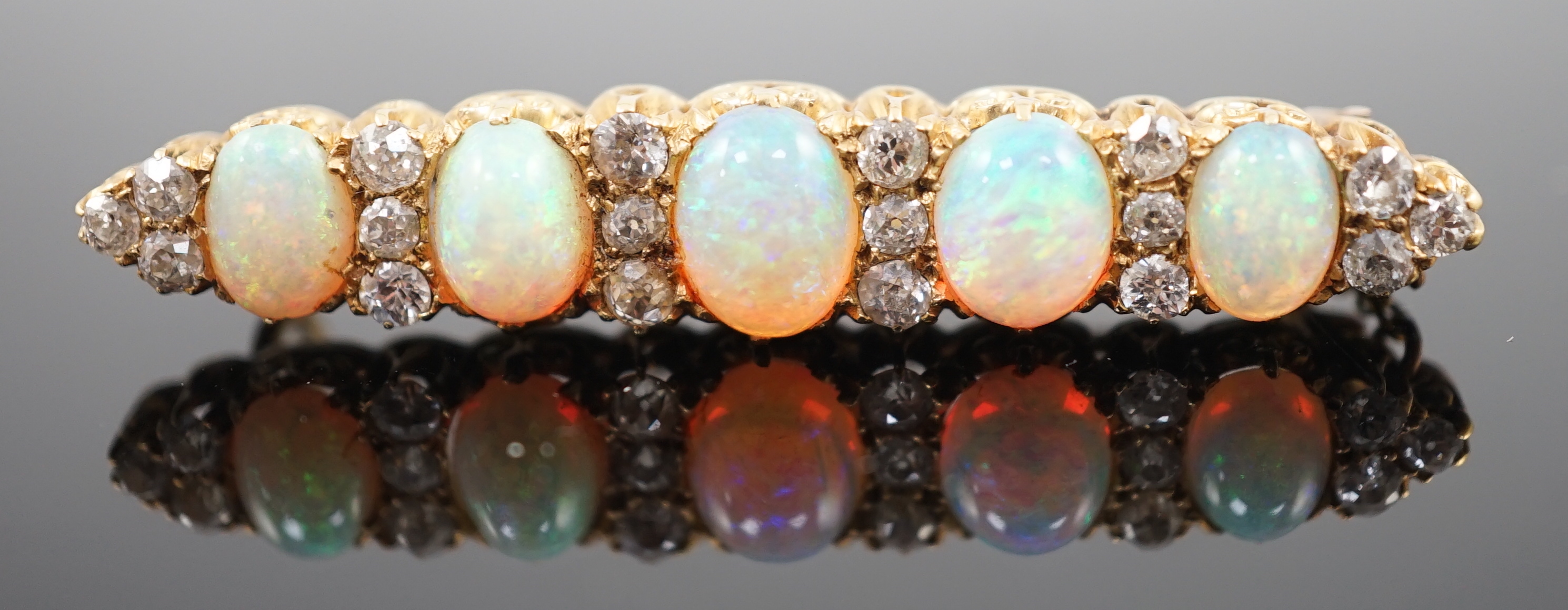 An early 20th century gold, diamond and oval white opal cluster set clip bar brooch